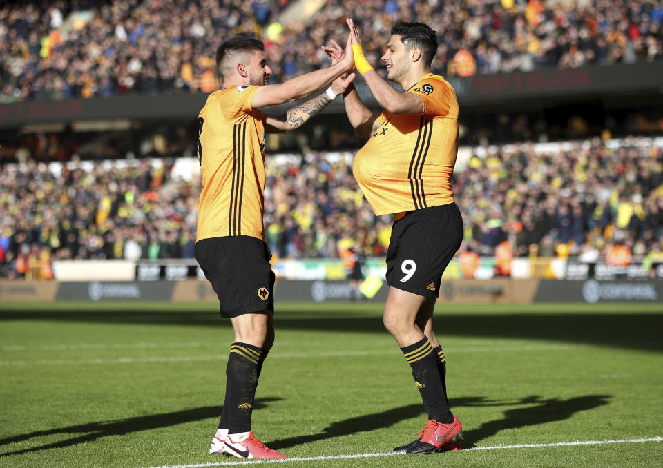 Wolverhampton Wanderers' Raul Jimenez, right, celebrates scoring against Norwich City during the English Premier League soccer match at Molineux, Wolverhampton, England, Sunday Feb. 23, 2020. (Nick Potts/PA via AP)