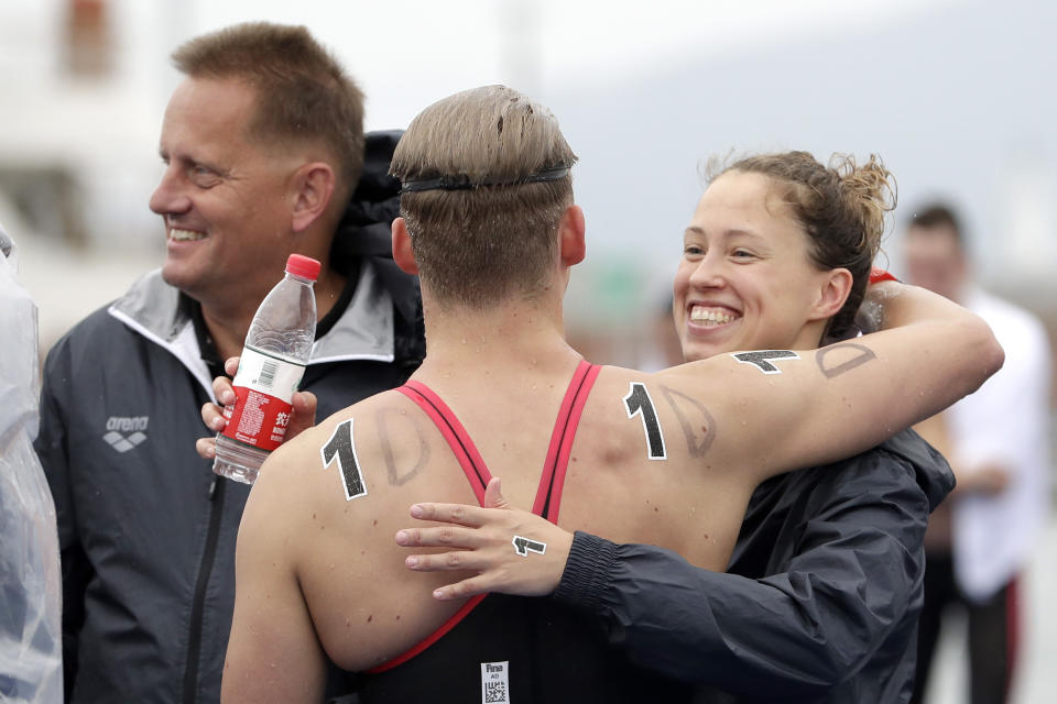 Members of the German team react after winning the 5km mixed relay open water swim at the World Swimming Championships in Yeosu, South Korea, Thursday, July 18, 2019. (AP Photo/Mark Schiefelbein)