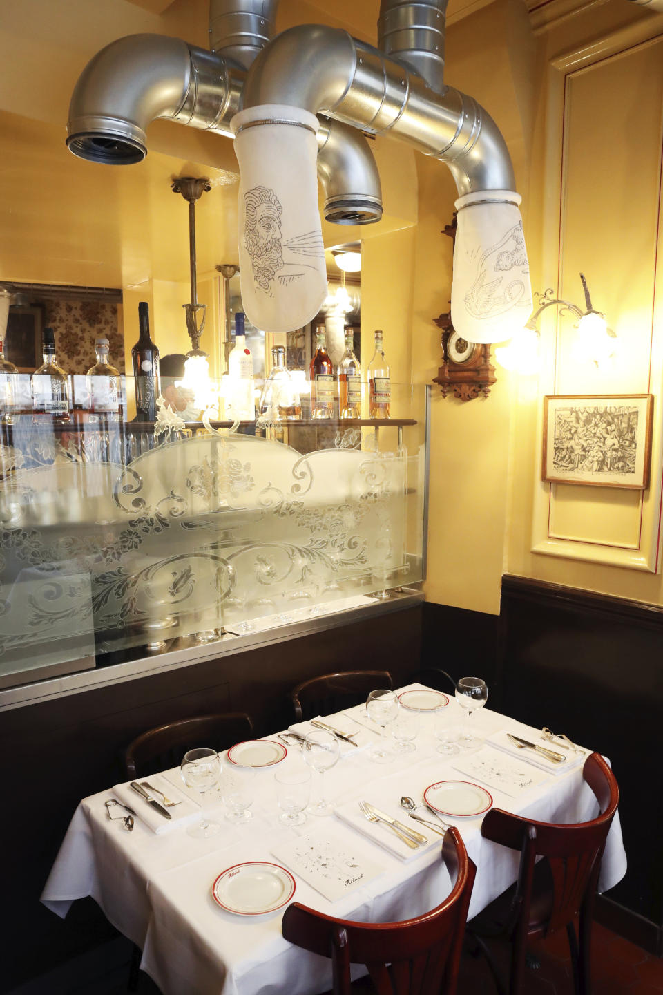 Filtration system is placed to prevent the new coronavirus particles to travel in the air, in the Alain Ducasse's restaurant « Allard », in Paris, Thursday, June 11, 2020. French Michelin-starred chef Alain Ducasse unveils virus-protection measures as he prepares to reopen his restaurants, including a new filtration system that works to stop virus particles from the air traveling to neighboring tables. (AP Photo/Thibault Camus)