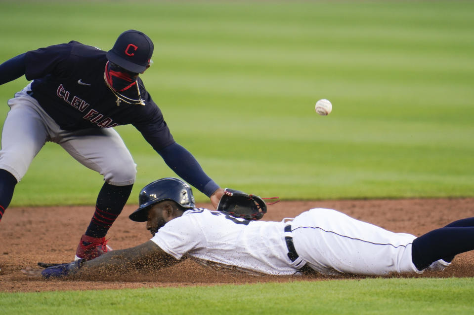 Detroit Tigers' Niko Goodrum steals second base as Cleveland Indians shortstop Francisco Lindor can't handle the throw during the third fourth inning of a baseball game in Detroit, Saturday, Aug. 15, 2020. (AP Photo/Paul Sancya)