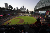 Fans arrive at Minute Maid Park where the roof on the stadium was open for Game 2 of baseball's World Series between the Houston Astros and the Atlanta Braves Wednesday, Oct. 27, 2021, in Houston. (AP Photo/Ashley Landis)