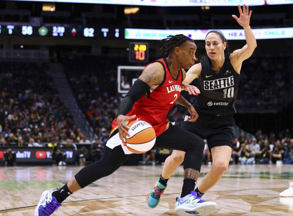 FILE - Las Vegas Aces guard Riquna Williams (2) drives against Seattle Storm guard Sue Bird (10) during the second half of Game 4 of a WNBA basketball playoffs semifinal Tuesday, Sept. 6, 2022, in Seattle. Las Vegas Aces player Riquna Williams has been accused of felony domestic violence involving a person authorities say is her spouse. A judge on Wednesday, July 26, 2023, said the veteran shooting guard can be freed from jail without bail but can't contact her alleged victim pending another court appearance next week.(AP Photo/Lindsey Wasson, File)