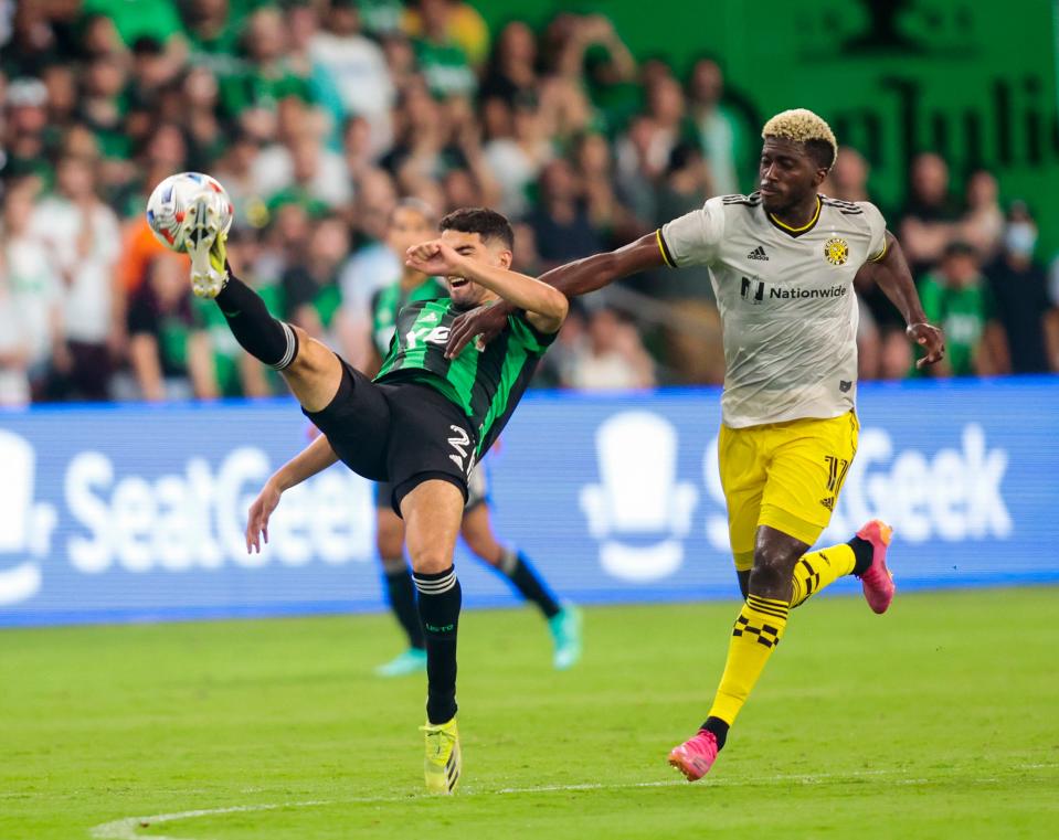 Austin FC's Manny Perez, left, bicycle kicks a shot past Columbus Crew forward Gyasi Zardes during their June 27, 2021 match at Q2 Stadium. El Tree signed Zardes on Monday.