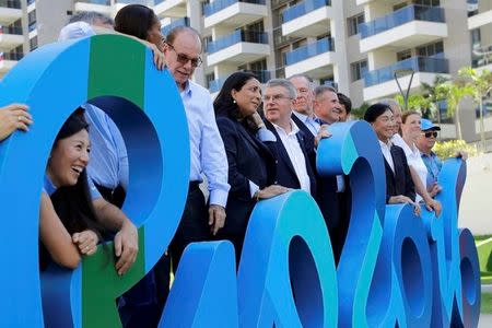 International Olympic Committee President Thomas Bach, center, poses with Olympic officials in athletes village in advance of the 2016 Olympic Games in Rio de Janeiro, Brazil, August 1, 2016. REUTERS/Patrick Semansky/Pool