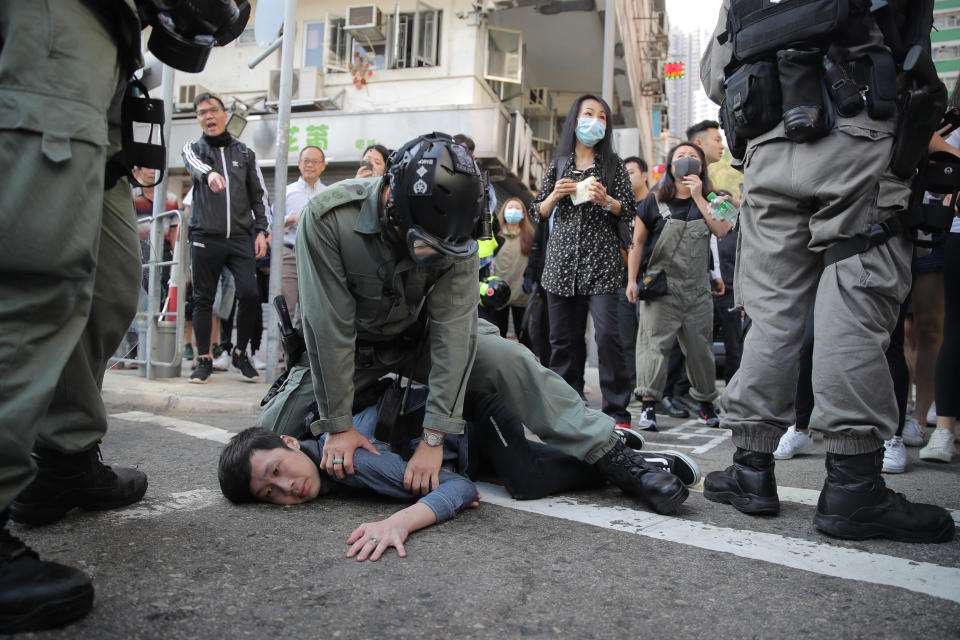 A protester is detained in Hong Kong Monday, Nov. 11, 2019. Hong Kong is in the sixth month of protests that began in June over a proposed extradition law and have expanded to include demands for greater democracy and other grievances. (AP Photo/Kin Cheung)