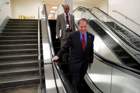 FILE PHOTO - U.S. Senator Doug Jones (D-AL) makes his way through the subway under the U.S. Capitol in Washington, U.S. January 4, 2018. REUTERS/Jonathan Ernst