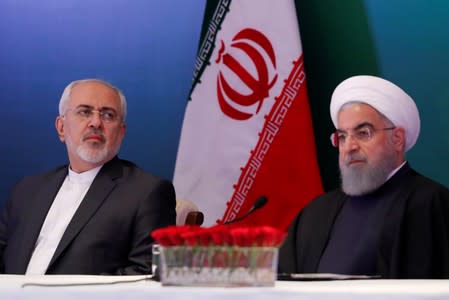 FILE PHOTO: Iranian President Hassan Rouhani (R) and Foreign Minister Mohammad Javad Zarif attend a meeting with Muslim leaders and scholars in Hyderabad
