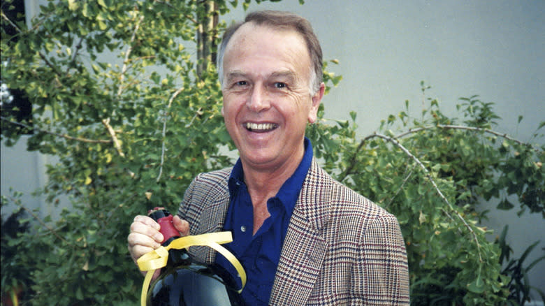 Joe Coulombe smiling wearing suit