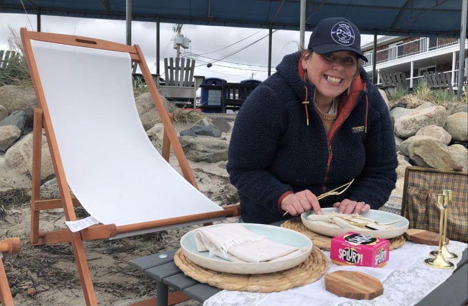 Megan Petrus sets a table for two at a picnic site she set up at Ogunquit Beach in Ogunquit, Maine, on May 4, 2023. Her new business, Sunrise Picnics, specializes in helping her clients create "core memories" they will always cherish.