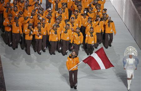 Latvia's flag-bearer Sandis Ozolins leads his country's contingent during the opening ceremony of the 2014 Sochi Winter Olympics, February 7, 2014. REUTERS/Lucy Nicholson