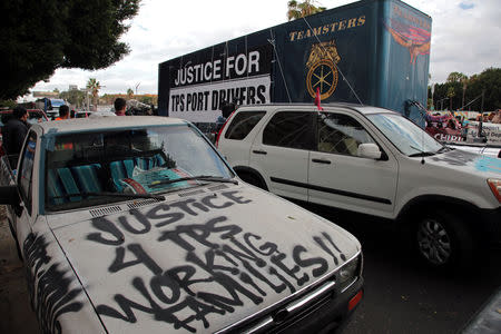 Members of the Teamsters Union participate in a tractor trailer caravan surrounding the LA Metro Detention Center in support of port truck drivers and others threatened by deportation if the courts or congress don't stop the termination of Temporary Protected Status (TPS) in Los Angeles, California, U.S. October 3, 2018. REUTERS/Kyle Grillot