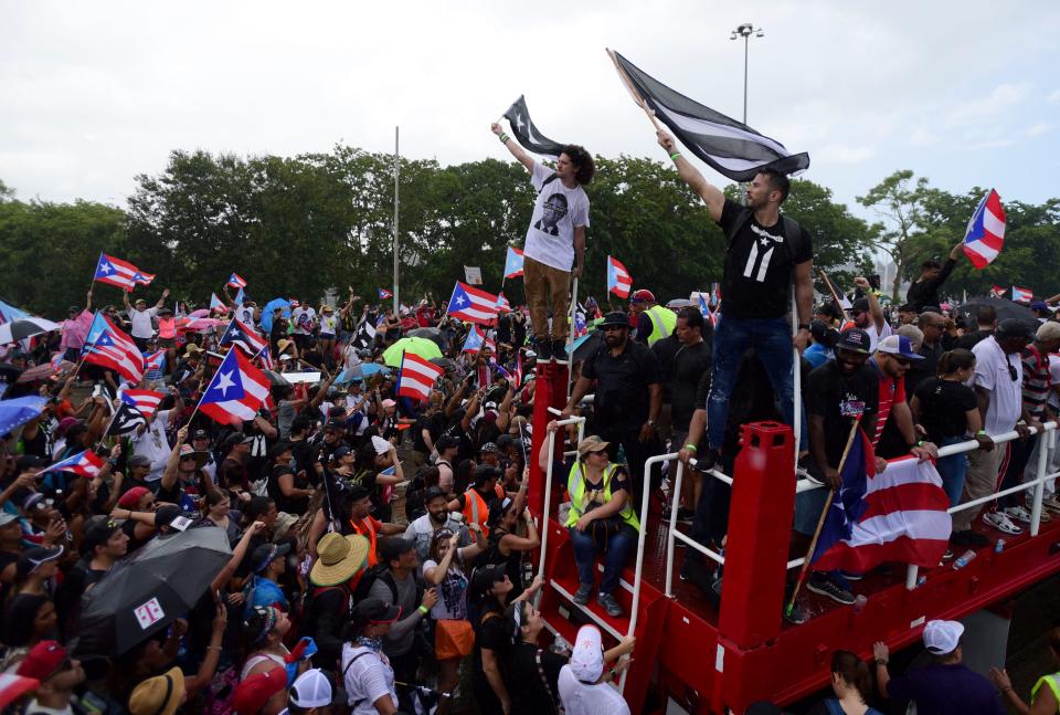 Demonstrators march on Las Americas highway demanding the resignation of governor Ricardo Rossello, in San Juan, Puerto Rico, Monday, July 22, 2019.