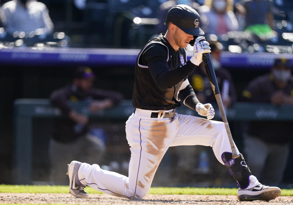 Colorado Rockies' Trevor Story reacts after swinging at and missing a pitch from San Diego Padres' Mark Melancon in the seventh inning of the first game of a baseball doubleheader Wednesday, May 12, 2021, in Denver. San Diego won 5-3. (AP Photo/David Zalubowski)