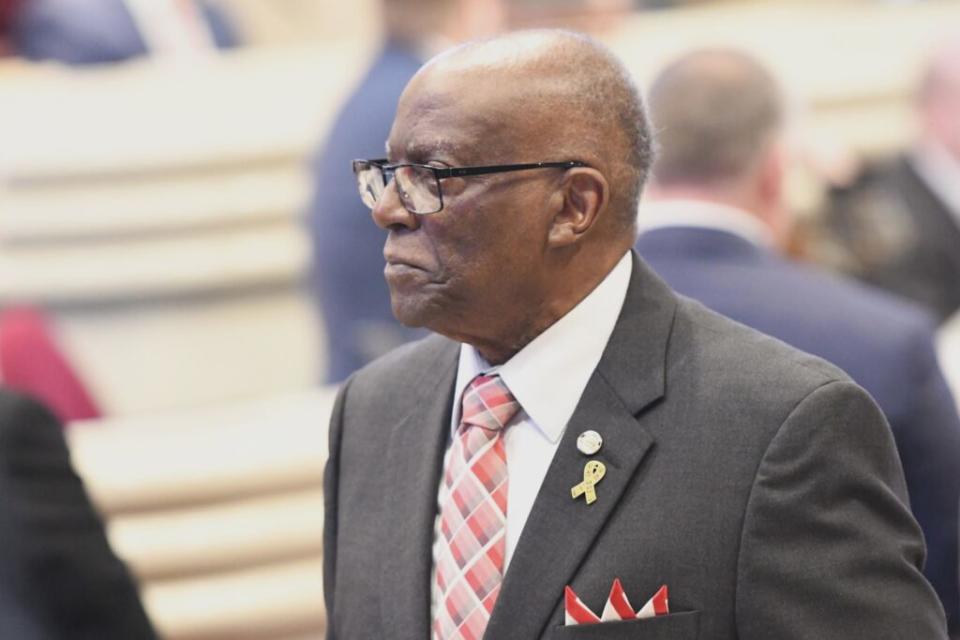 A man in a pink and white tie and a gray suit.