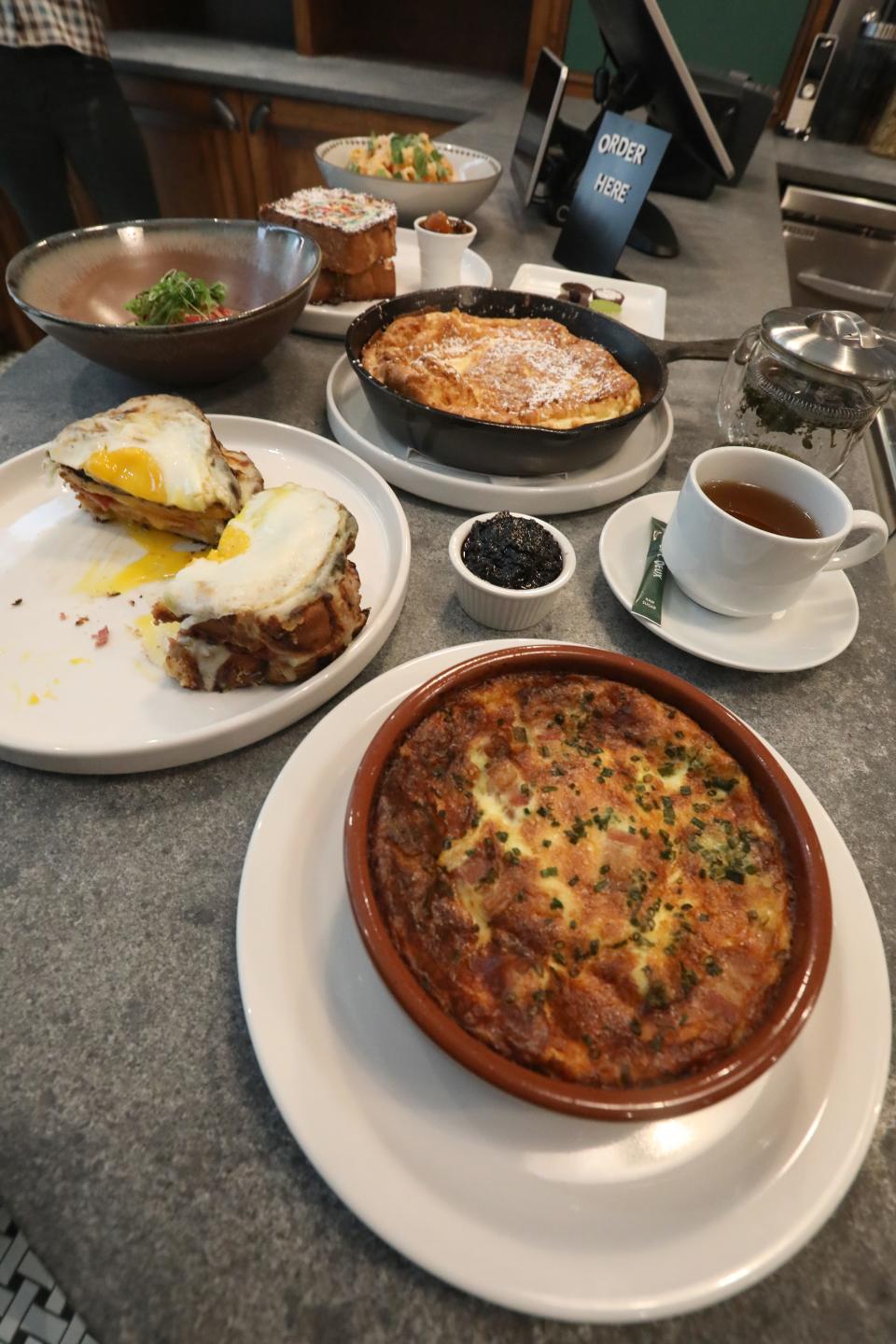 Crustless quiche, front, Croque Madame and Dutch baby dishes at Cafe Deux in Harrison March 17, 2023.