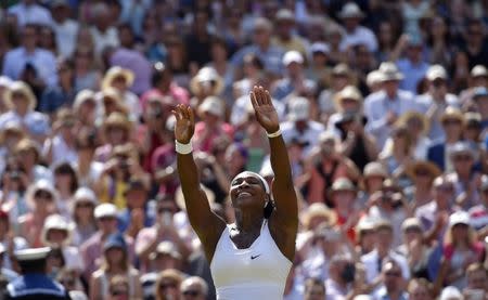 FILE PHOTO: Serena Williams of the U.S.A celebrates after winning her Women's Final match against Garbine Muguruza of Spain at the Wimbledon Tennis Championships in London, July 11, 2015. REUTERS/Toby Melville