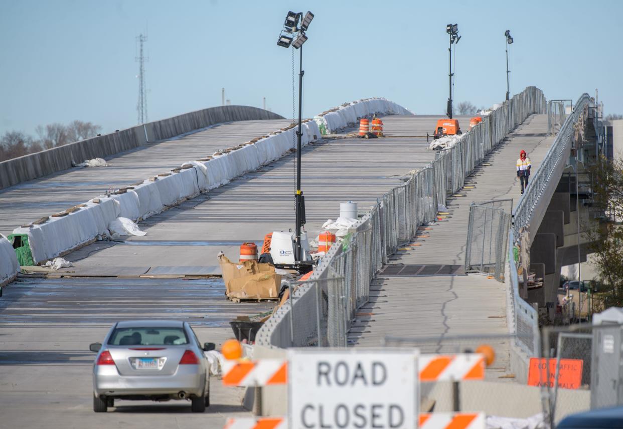 A pedestrian crosses the Bob Michel Bridge on the new and much wider sidewalk from Peoria to East Peoria. After eight months of renovation, theheavily-used bridge is expected to re-open for traffic in mid-December.