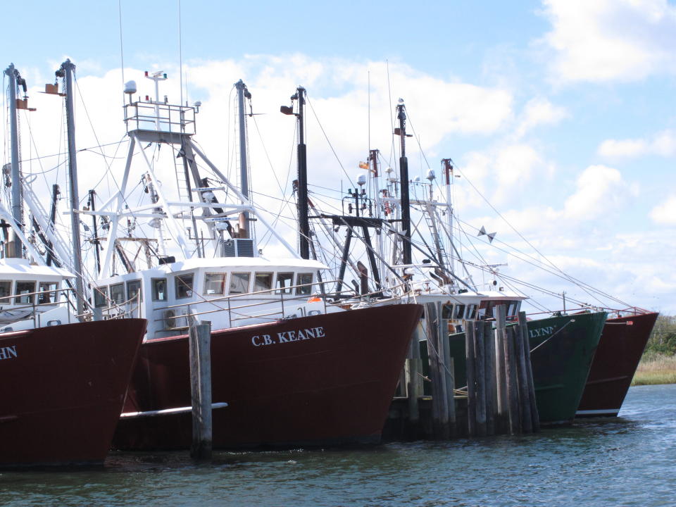This Sept. 13, 2019 photo shows commercial fishing vessels at port in Barnegat Light, N.J. Although they support efforts to fight climate change and its impact on the world's oceans, the fishing industry fears it could be harmed by one of the promising solutions: the offshore wind energy industry. At a Congressional subcommittee hearing Monday Sept. 16, 2019 in New Jersey, fishermen asked for a seat at the table when important wind energy decisions are made, including where projects are located. (AP Photo/Wayne Parry)