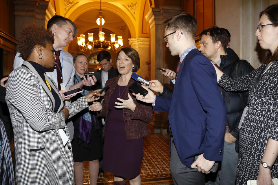 Sen. Amy Klobuchar, D-Minn., center, talks to reporters as she arrives at the Capitol in Washington, Wednesday, Jan. 22, 2020. The U.S. Senate plunges into President Donald Trump's impeachment trial with Republicans abruptly abandoning plans to cram opening arguments into two days but solidly rejecting for now Democratic demands for more witnesses to expose what they deem Trump's "trifecta" of offenses. Trump himself claims he wants top aides to testify, but qualified that by suggesting there were "national security" concerns to allowing their testimony. (AP Photo/Julio Cortez)