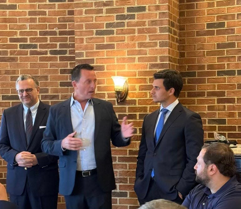 Richard Grenell, former Ambassador to Germany and former acting director of National Intelligence under President Donald Trump, speaks to Arab American leaders on May 21, 2024, at Maggiano's Little Italy restaurant in Troy, Michigan. On his left is Michael Boulos, a son-in-law of Trump married to Tiffany Trump who's of Lebanese descent. On Grenell's right is Boulos' father, Massad Boulos. Sitting in front is Mike Hacham, of Dearborn, the Michigan coordinator for Arab Americans for Trump