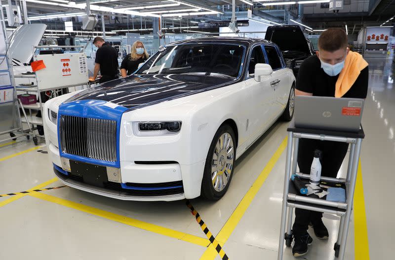 Technicians inspect a Rolls-Royce a car on the production line of the Rolls-Royce Goodwood factory, near Chichester