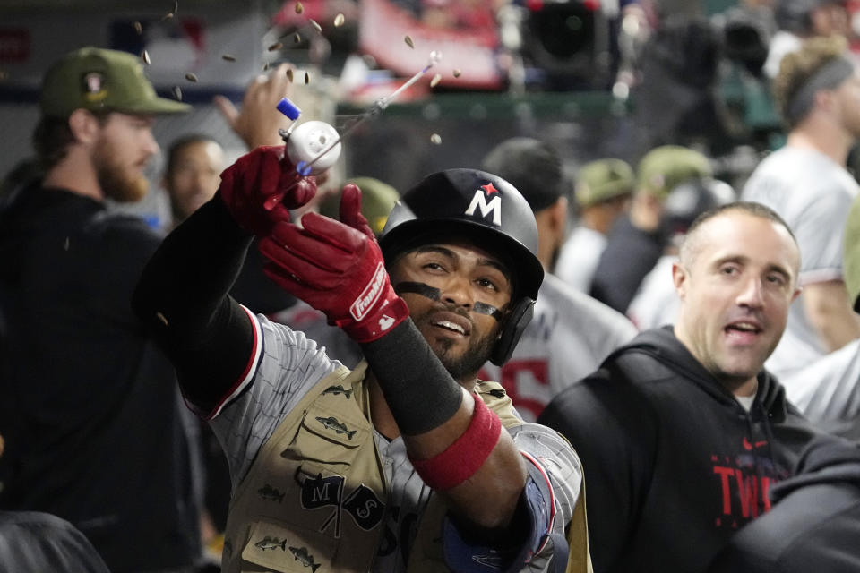 Minnesota Twins' Willi Castro handles a fishing pole in the dugout as sunflower seeds fly through the air after hitting a solo home run during the seventh inning of a baseball game against the Los Angeles Angels Friday, May 19, 2023, in Anaheim, Calif. (AP Photo/Mark J. Terrill)