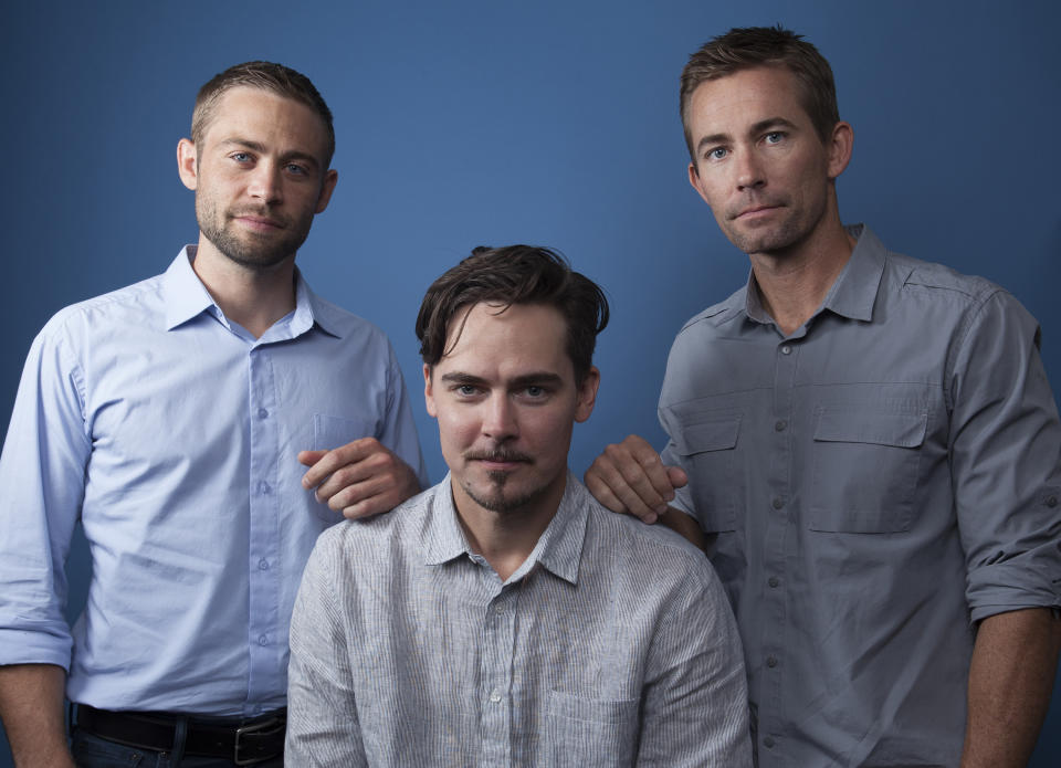 In this Wednesday, Aug. 8, 2018 photo, Cody Walker, from left, Adrian Buitenhuis and Caleb Walker, pose for a portrait in Los Angeles, in promotion of the documentary film "I Am Paul Walker." The new one-hour documentary about the actor's childhood, family and career is directed by Buitenhuis. It premiered last weekend on the Paramount Network. (Photo by Rebecca Cabage/Invision/AP)