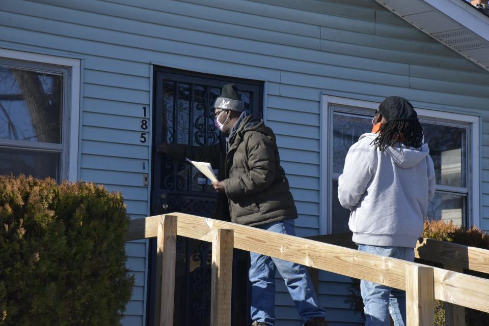 Richard Smith and Jermahn Williams canvas the Washington Heights neighborhood to solicit residents to sign up for a free Ring 3 doorbell and subscription offered through the nonprofit RISE Corp. on Friday, Jan. 21, 2022.