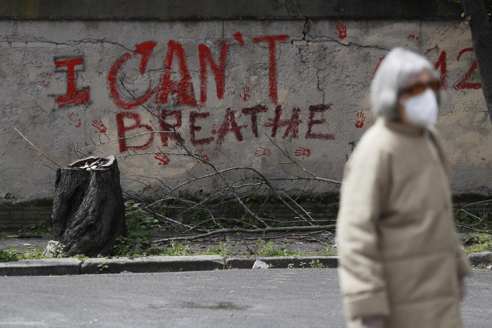 A graffiti reading "I Can't Breathe" is seen on a wall in Rome, Wednesday, April 21, 2021. After three weeks of testimony, the trial of the former police officer charged with killing George Floyd ended swiftly: barely over a day of jury deliberations, then just minutes for the verdicts to be read — guilty, guilty and guilty — and Derek Chauvin was handcuffed and taken away to prison. The guilty verdict in the George Floyd trial was not just America's victory. It signaled hope for those seeking racial justice and fighting police brutality across the Atlantic. (AP Photo/Gregorio Borgia)