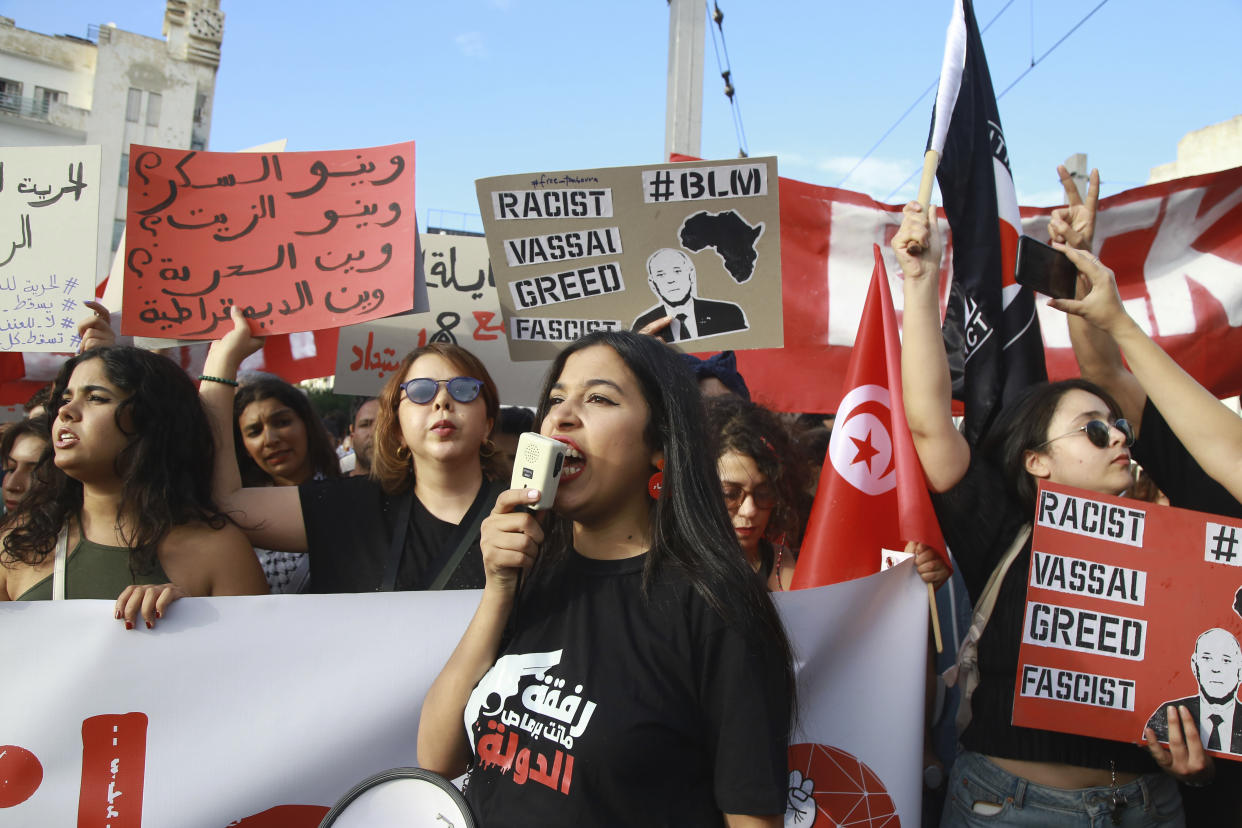 Tunisian take part in a protest against President Kais Saied ahead of the upcoming presidential elections, Friday, Sept. 13, 2024, on Avenue Habib Bourguiba in the capital Tunis. Banner in Arabic reads "Where is sugar? Where is oil? Where is freedom? Where is democracy?" (AP Photo/Anis Mili)