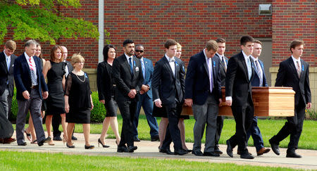 FILE PHOTO: Fred and Cindy Warmbier follow the casket of their son, Otto Wambier, to the hearse after his funeral at Wyoming High School in Wyoming, Ohio, U.S. June 22, 2017. REUTERS/John Sommers II/File Photo