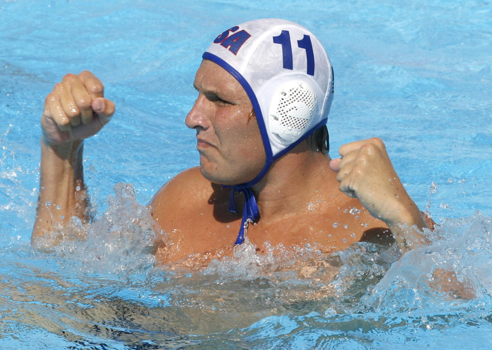 FILE - In this July 28, 2009, file photo, Jesse Smith, of the United States, reacts during a waterpolo quarterfinal match against Germany at the FINA Swimming World Championships in Rome. One way Smith is dealing with the coronavirus pandemic is through virtual speaking engagements with water polo clubs and teams all over the country, passing along what he has learned during a couple decades in the water. (AP Photo/Alessandra Tarantino, File)