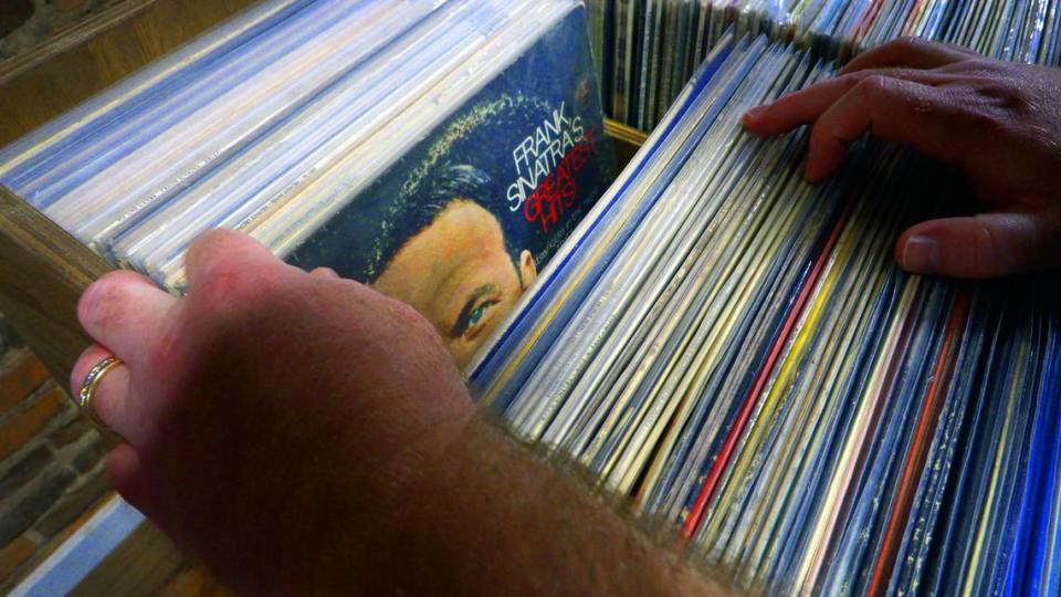 Brian Cook, the owner of Blue Canary Records in Columbus, Georgia, flips through his extensive selection of Frank Sinatra records. 07/13/2023 Mike Haskey/mhaskey@ledger-enquirer.com