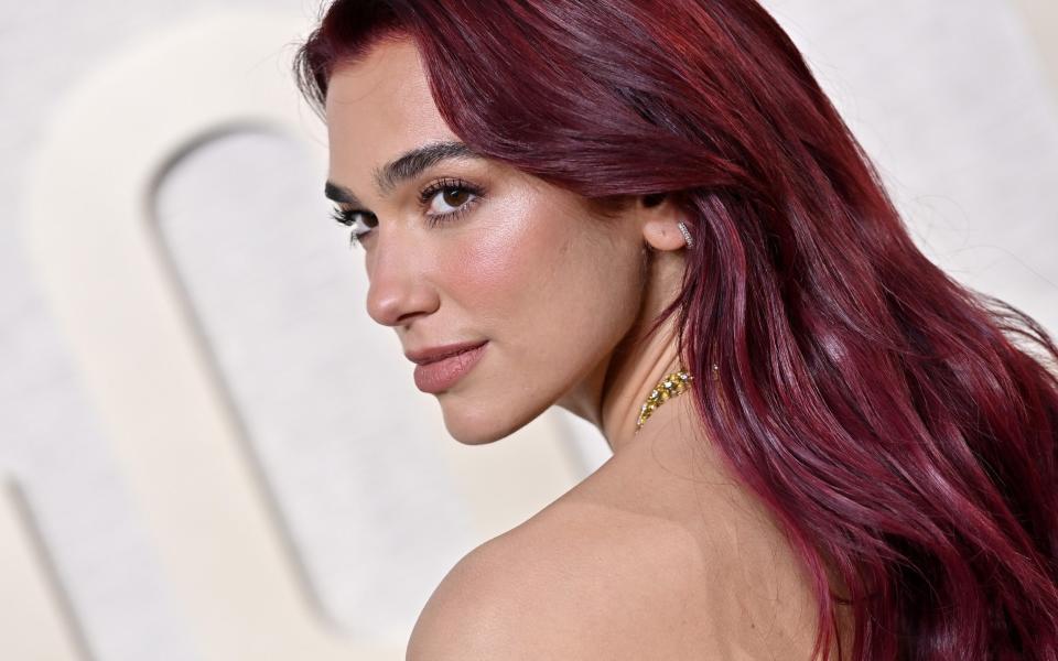 Dua Lipa opts for plum - a purple toned red