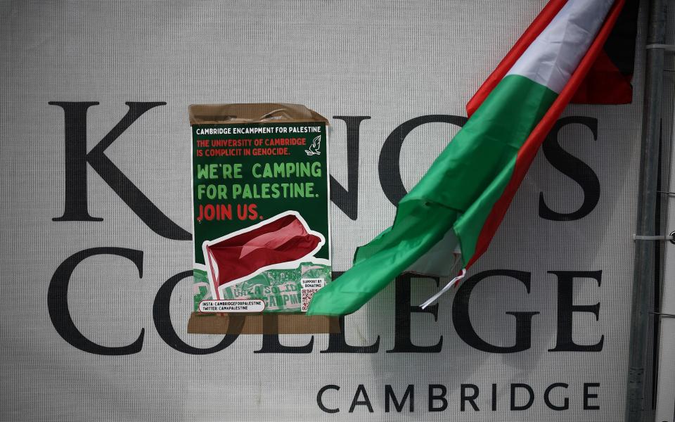 Protesters on the lawn outside King's College, Cambridge have distributed flyers calling for fellow students to join the protests