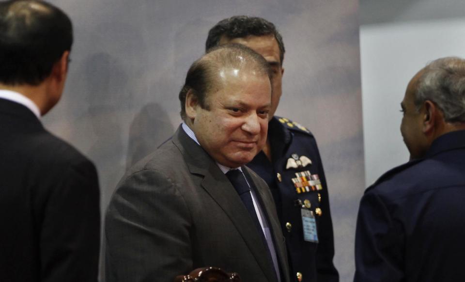 In this Wednesday, Dec. 18, 2013 photo, Pakistan's Prime Minister Nawaz Sharif attends a ceremony at Aeronautical Complex in Kamra, near Islamabad, Pakistan. Sherif said on Wednesday, Jan. 29, 2014, his government will pursue peace talks with militants despite a recent spate of attacks, naming a four-member committee to facilitate the talks. (AP Photo/Anjum Naveed)