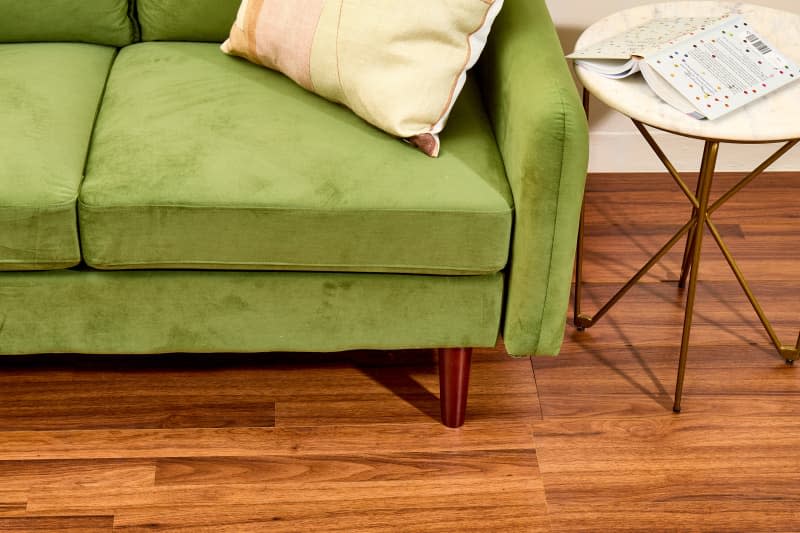 overhead shot of the cleaned floors with a green velvet couch peeking in.