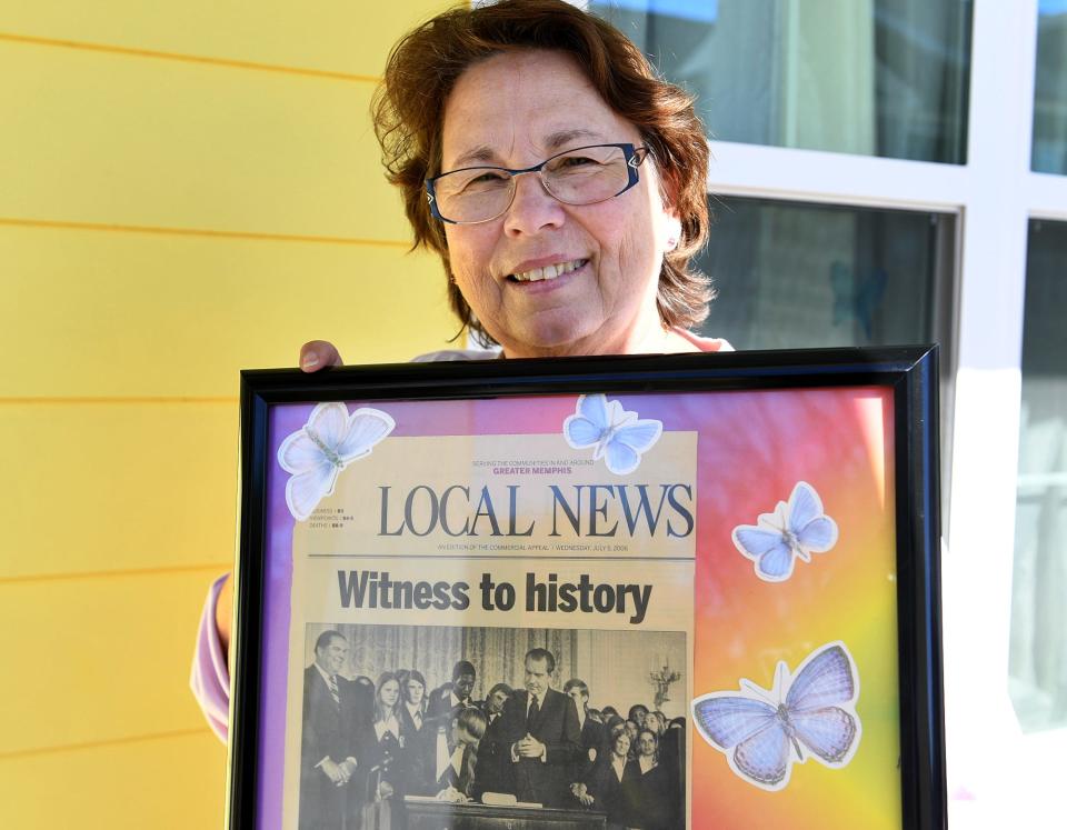 Julianne Jones Shapard holds up an article clipping from The Commercial Appeal with a photo of her signing the 26th Amendment to the United States Constitution in 1971. The amendment lowered the voting age to 18.