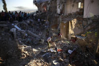 <p>Palestinians stand around a house demolished after a shootout between the Israeli military and a group of Palestinians in the village of Surif, near Hebron, West Bank, July 27, 2016. (Photo: Mahmoud Illean/AP)</p>