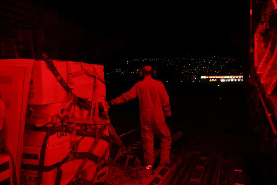 United Arab Emirates military member stands next to palettes of aid for Lebanon after cargo aircraft landed (REUTERS)