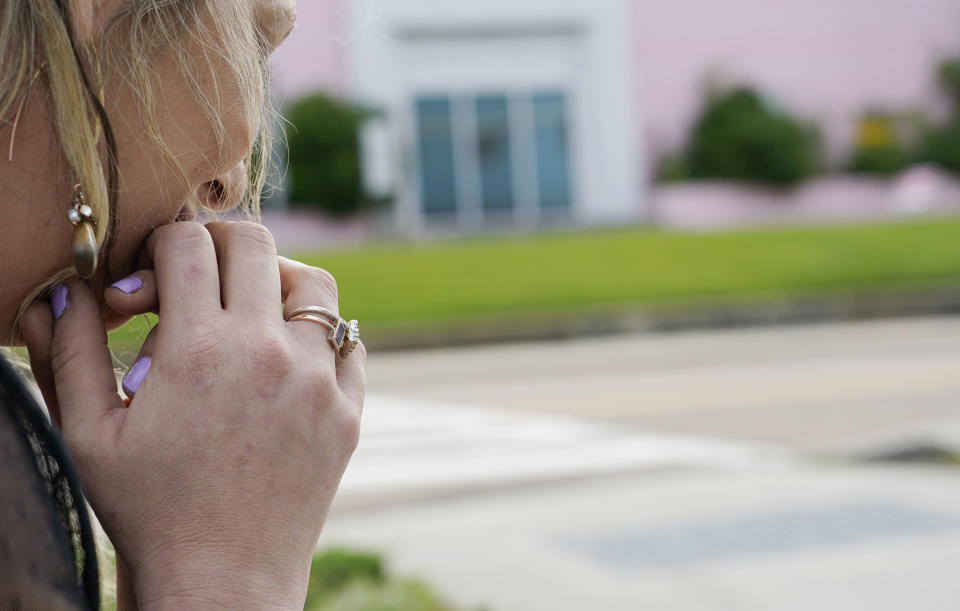 Sitting across the street from the Jackson Women's Health Organization clinic, more commonly called "the pink house" by area residents in Jackson, Miss., a woman, who has ended two pregnancies at the clinic said she has never had a moment's regret over those decisions, Wednesday, May 19, 2021. At the time, she was in her 30s and did what was best for herself and her young child, she said. (AP Photo/Rogelio V. Solis)