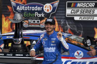 Kyle Larson (5) celebrates after winning a NASCAR Cup Series auto race at Texas Motor Speedway Sunday, Oct. 17, 2021, in Fort Worth, Texas. (AP Photo/Randy Holt)