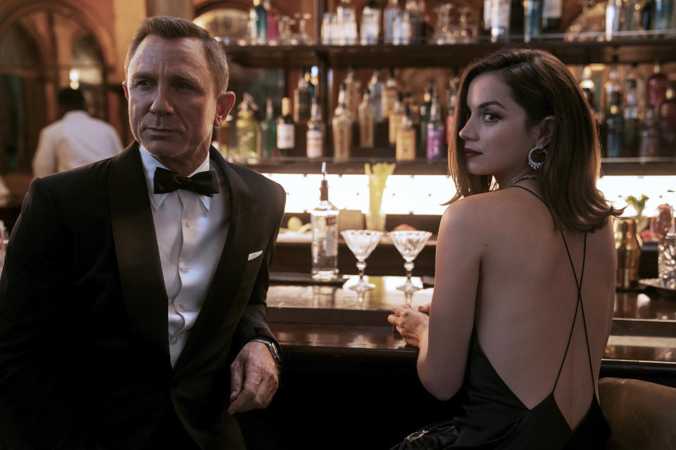 This image released by MGM shows Daniel Craig, left, and Ana de Armas in a scene from "No Time To Die," in theaters on Oct. 8. (Nicola Dove/MGM via AP)