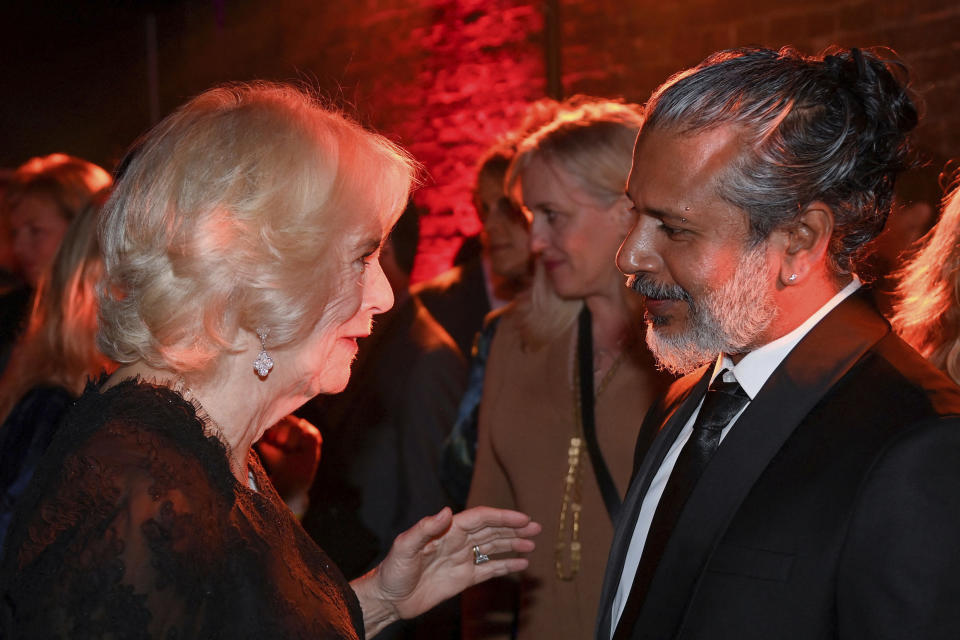 Britain's Camilla, Queen Consort talks with shortlisted author Shehan Karunatilaka during the Booker Prize at the Roundhouse in London, Monday Oct. 17, 2022. (Toby Melville/Pool via AP)