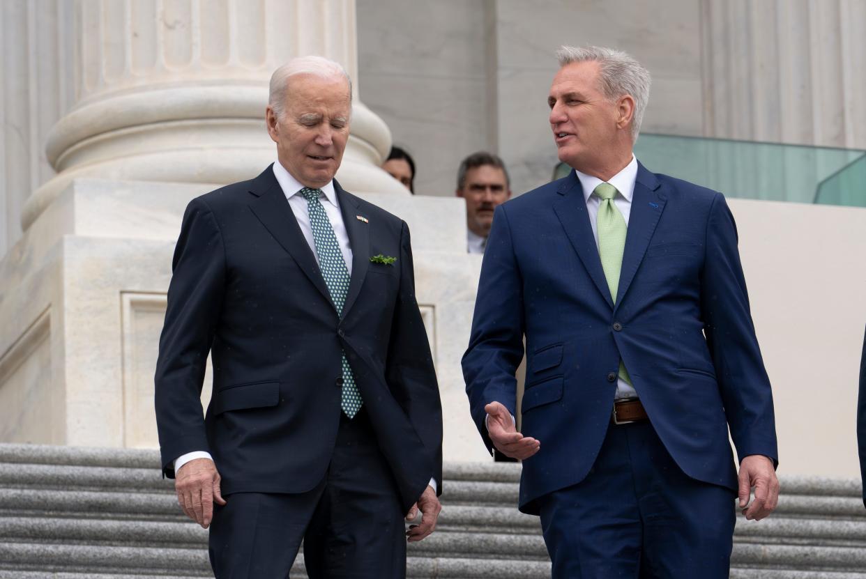 President Joe Biden walks with House Speaker Kevin McCarthy, R-Calif., as he departs the Capitol following the annual St. Patrick's Day gathering, in Washington, Friday, March 17, 2023. Facing the risk of a government default as soon as June 1, President Joe Biden invited the top four congressional leaders to a White House meeting for talks.