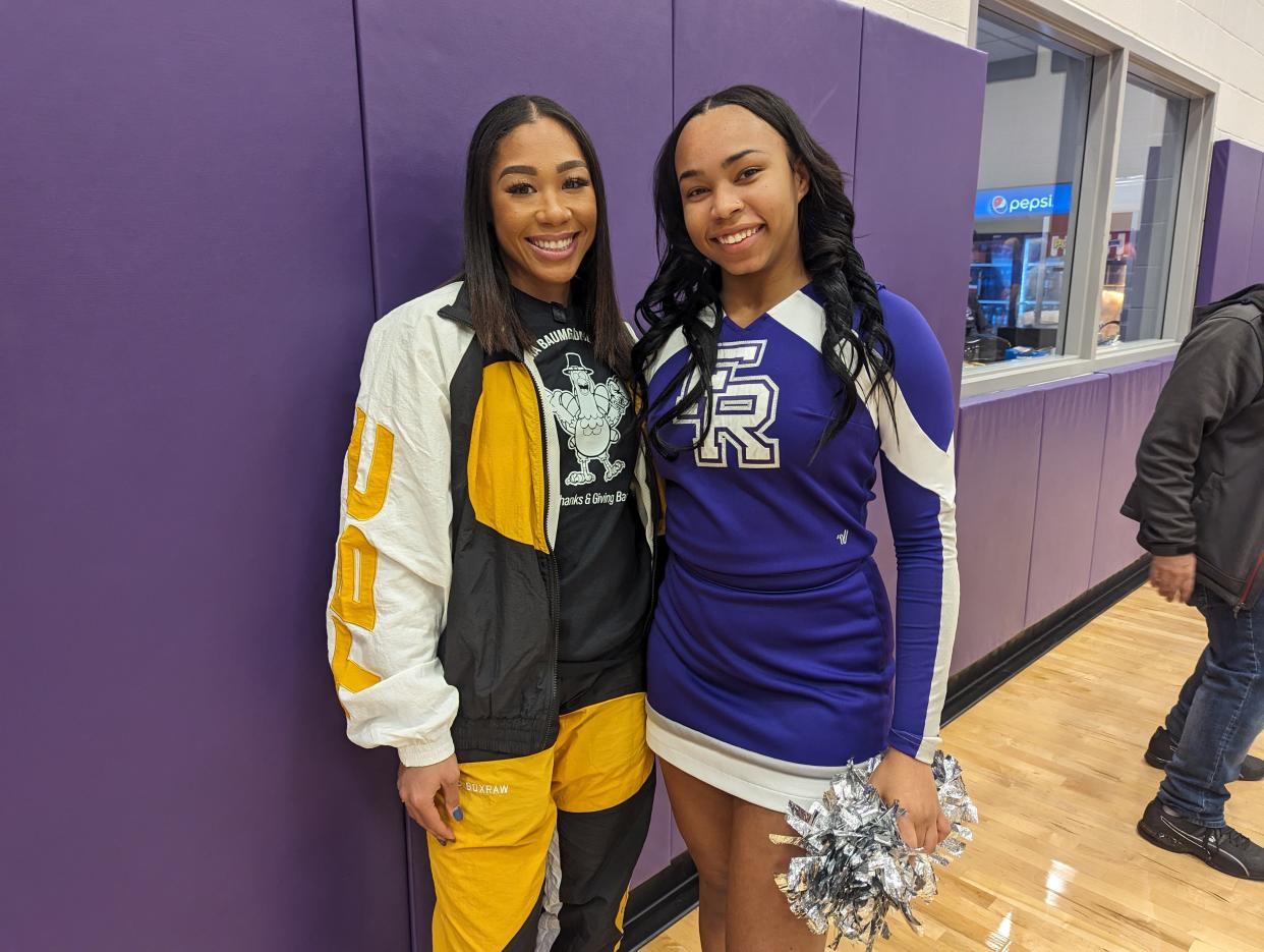 World champion boxer Alycia Baumgardner stops to speak and pose for selfies with Fremont Ross cheerleader Briyana Simms on Nov. 9, 2023, during a basketball rally at the high school, which was also a Thanksgiving turkey giveaway Baumgardner sponsored.