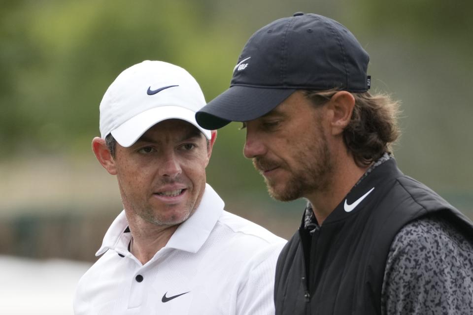 Rory McIlroy of Northern Ireland, left, talks to Tommy Fleetwood of England on the 11th hole during the first round of the Dubai Desert Classic, in Dubai, United Arab Emirates, Thursday, Jan. 26, 2023. (AP Photo/Kamran Jebreili)