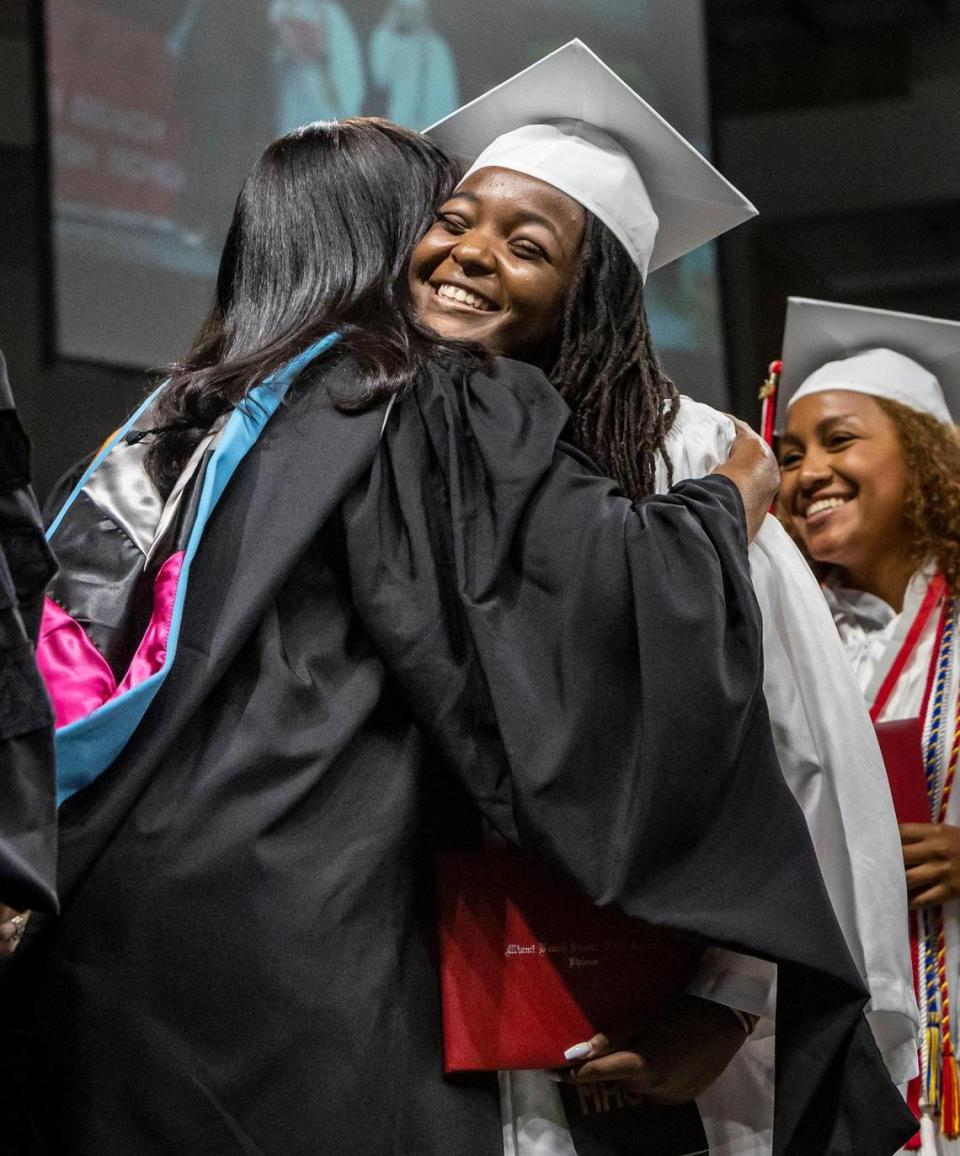 Ashley Adirika is congratulated by teachers and other guests after receiving her diploma during the Miami Beach High commencement ceremonies in the Watsco Center at the University of Miami.