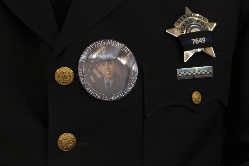 A pin on a police officer's coat shows Chicago police Officer Andres Vasquez-Lasso at St. Rita of Cascia Shrine Chapel during a funeral Mass for Vasquez-Lasso in Chicago. Vasquez-Lasso was shot and killed as he responded to reports of a man chasing a woman with a gun in Gage Park. (Stacey Wescott/Chicago Tribune via AP, Pool)