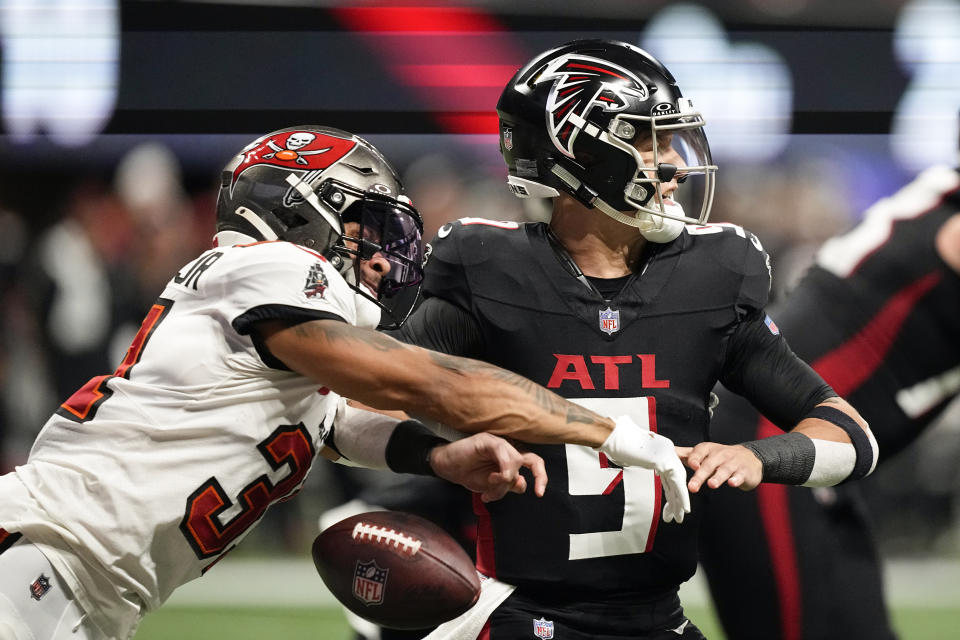 APTOPIX Tampa Bay Buccaneers safety Antoine Winfield Jr. (31) strips the ball from Atlanta Falcons quarterback Desmond Ridder (9) during the first half of an NFL football game, Sunday, Dec. 10, 2023, in Atlanta. Atlanta recovered the ball in the end zone resulting in a safety. (AP Photo/Brynn Anderson)